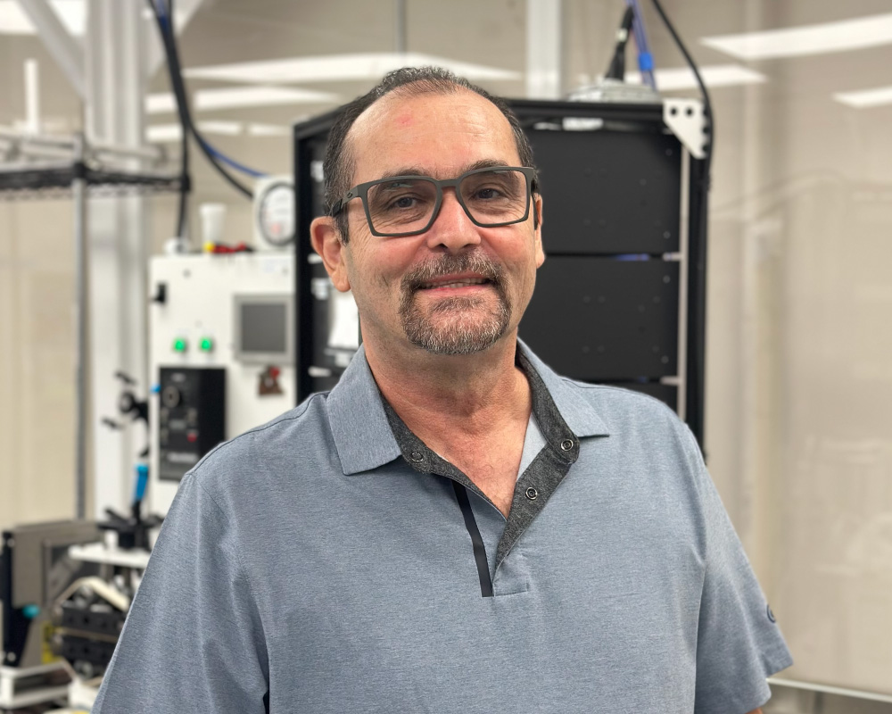 Viant Senior Extrusion Expert Sixto Hernandez inspecting prototype medical tubing