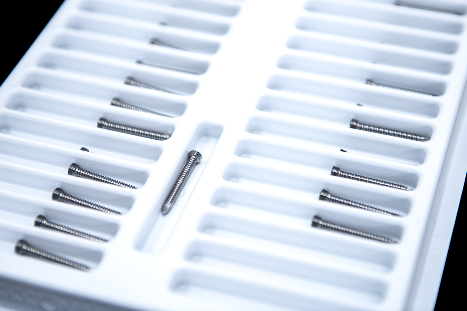 Sterilized orthopedic surgical screws in white plastic tray