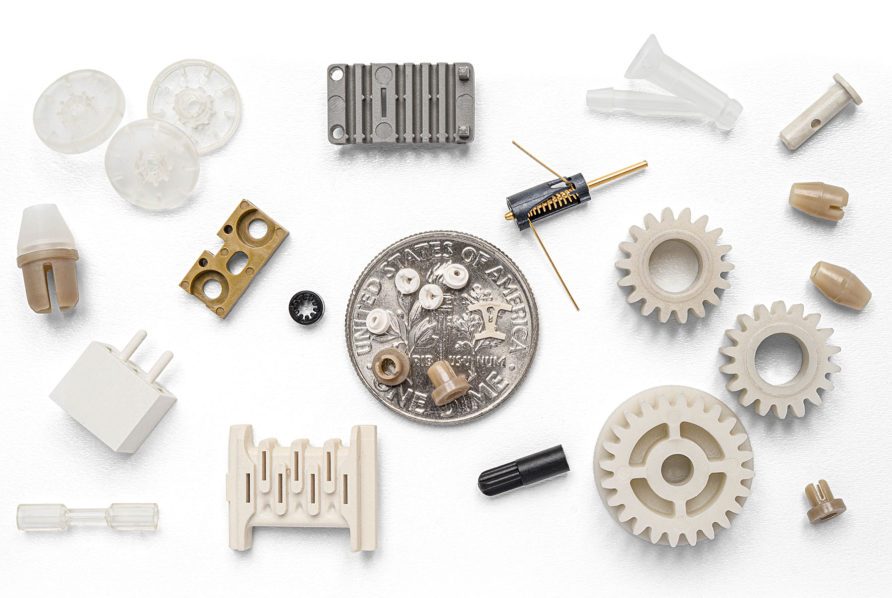 Micro molding medical components next to a dime