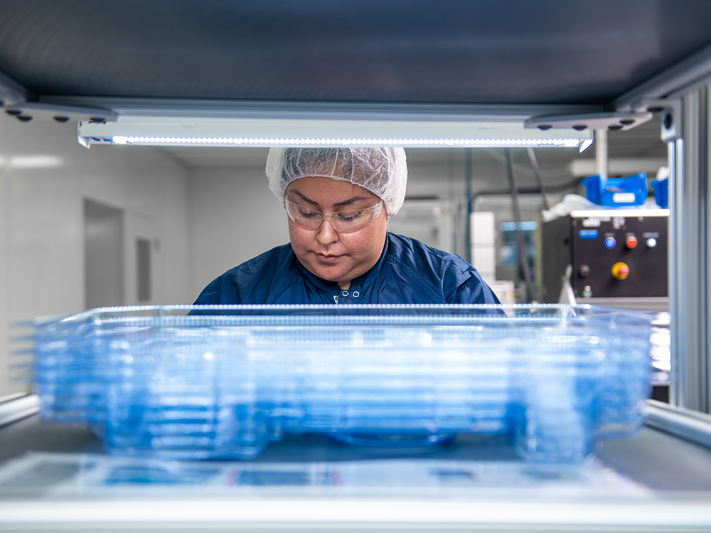 Technician conducting final serialization labeling inspection