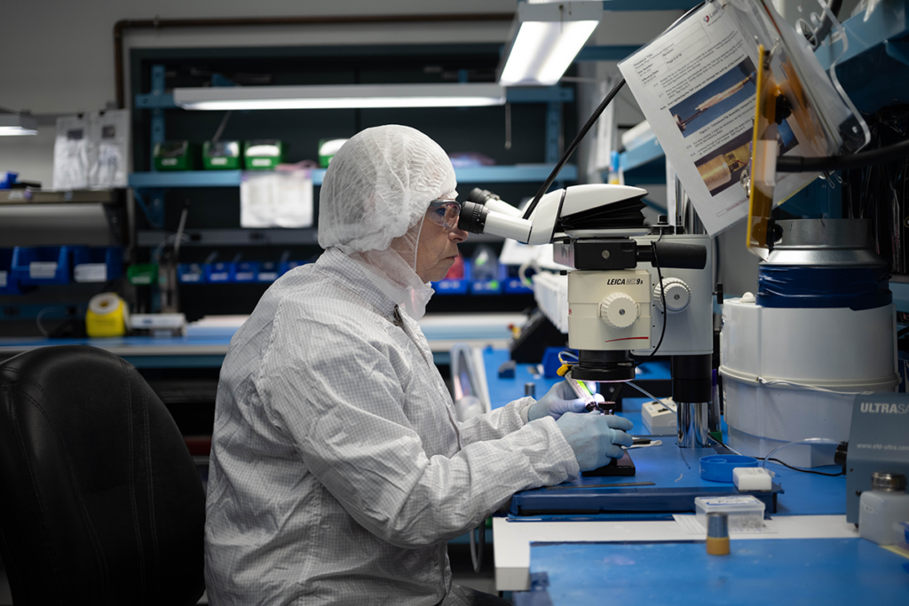 Cleanroom technician inspecting sterile surgical component