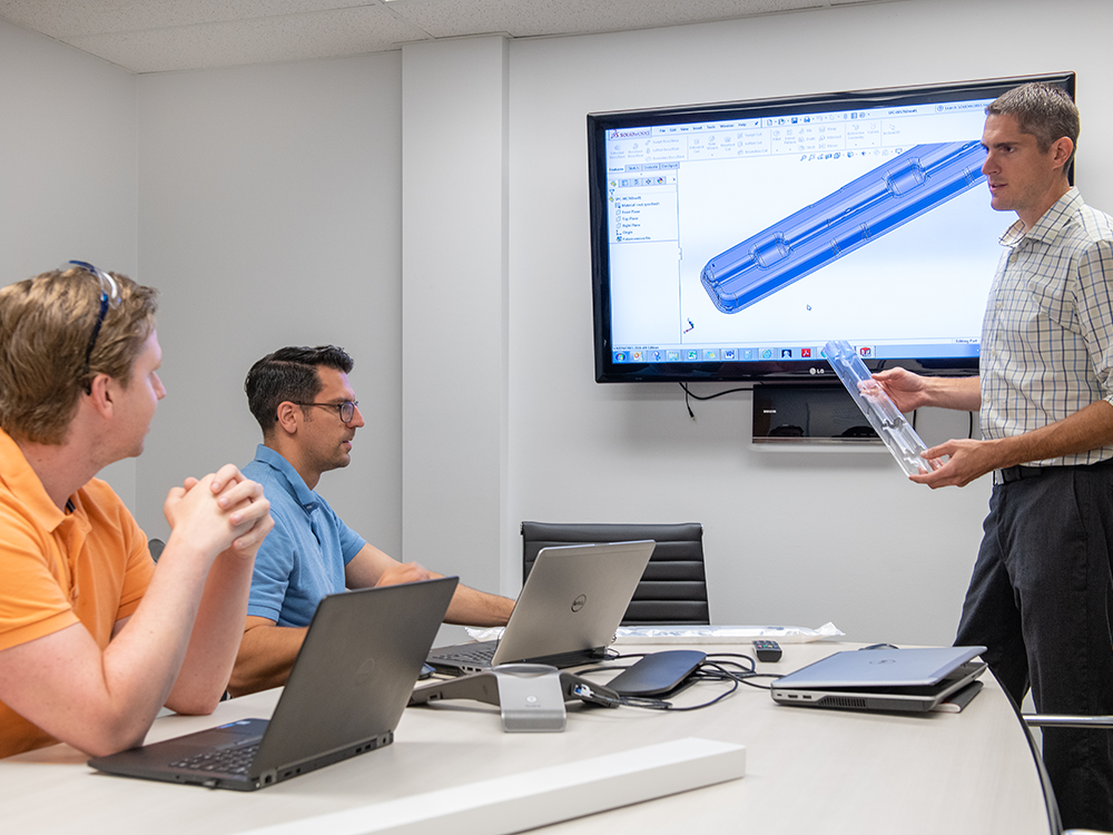 Engineering team reviewing CAD models for thermoformed medical trays